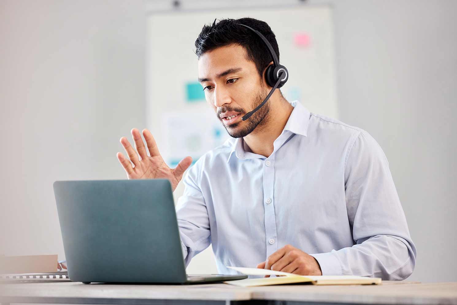 A business professional helping a customer on the phone.