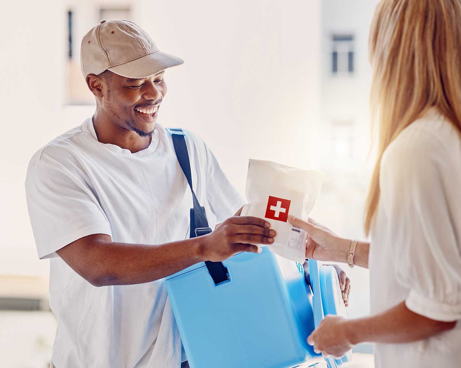 A medical courier delivering a prescription to a woman at her house.