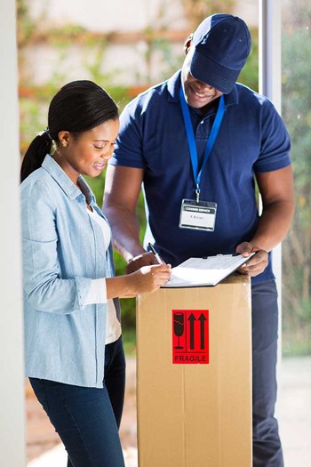 Customer signing for delivery from courier with uniform and brand