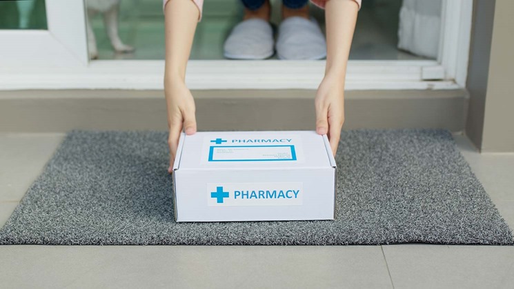 A pharmacy courier service delivers a package